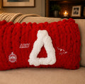 Handmade chunky knit pillow in crimson red with white Delta Sigma Theta Greek letters and emblem patches