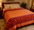 Handmade chunky knit queen bedspread in peach, burnt orange and burgundy tones