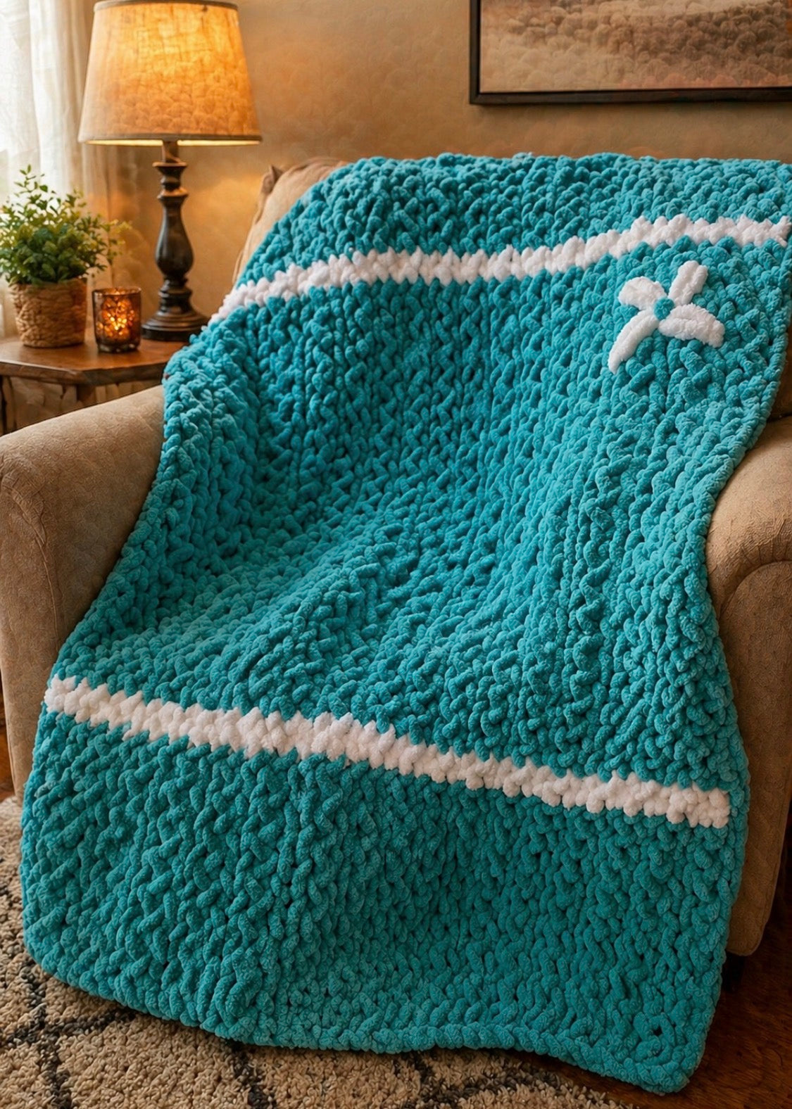 Handmade chunky knit throw in aqua and white with white stripe accents and flower patch